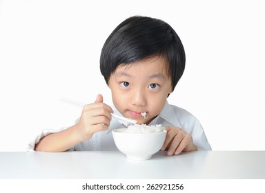 Asian Boy Eating A Bowl Of Rice With Chopsticks