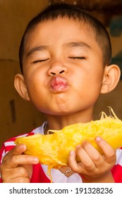 Asian Boy Eating Yellow Mango.