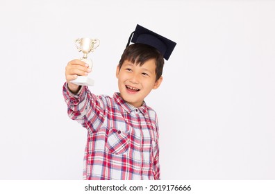 An Asian Boy Excited About His Winning Sport Medal And Trophy