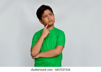 Asian boy with an expression is thinking about something