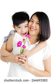 Asian Boy Giving Carnation Flower To His Mother On Mothers Day