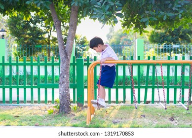 Asian Boy Hang The Monkey Bar Or Balance Bar For Balance At Outdoor Playground In Summer.