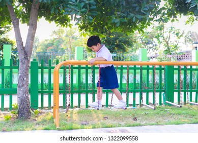 Asian Boy Hang The Monkey Bar Or Balance Bar For Balance At Outdoor Playground In Summer.