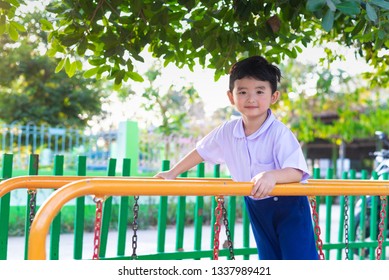 Asian Boy Hang The Monkey Bar Or Balance Bar For Balance At Outdoor Playground In Summer.