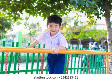 Asian Boy Hang The Monkey Bar Or Balance Bar For Balance At Outdoor Playground In Summer.