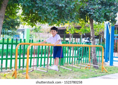 Asian Boy Hang The Monkey Bar Or Balance Bar For Balance At Outdoor Playground In Summer.