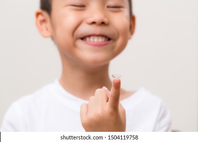 Asian Boy Hold With A Contact Lens