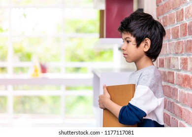 Asian Boy Is Holding Book Side View