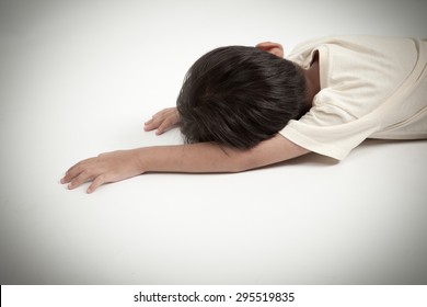 Asian Boy Kid Lying Down On White Floor Like Accident Or Fainting 