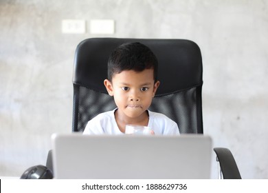 Asian Boy Kid Sitting At Table With Laptop And Preparing To School. Online Education Concept. Online Video Call Conference Class Lesson Study.