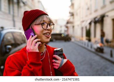 Asian Boy Laughing And Talking On Mobile Phone At City Street