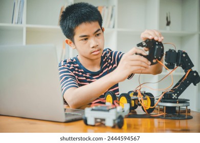 Asian boy learning and studying the work of technology robots.homeschool and science for tech project. playing childhood kids hobby leisure lifestyle people toys robotics technology.