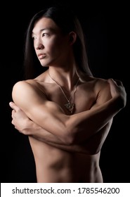 Asian Boy With Long Hair Over Dark Background