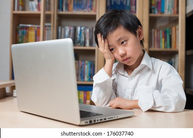 Asian Boy Looking Frustrated In Front Of Laptop Computer 