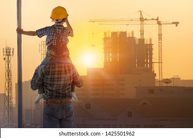 Asian boy on father's shoulders with background of new high buildings and silhouette construction cranes of evening sunset, father and son concept - Powered by Shutterstock