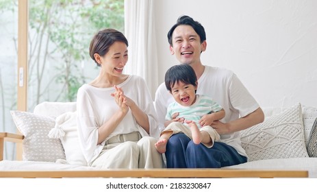 Asian Boy And Parents In The House. Family Concept.