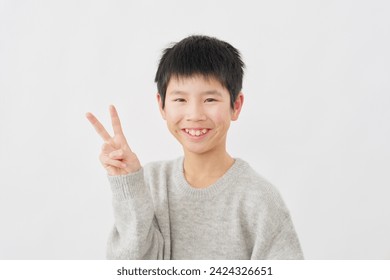 Asian boy peace sign gesture in white background