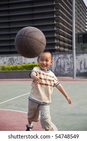 Asian Boy Playing Basketball With Great Fun