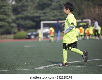 Asian Boy Playing Football With Happy