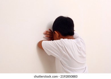 Asian Boy Playing Hide And Seek. Asian Boy Crying On The Wall. Isolated On White.