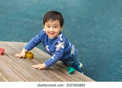 Asian boy is playing in playground with happy face in summer. Copy space for text - Powered by Shutterstock