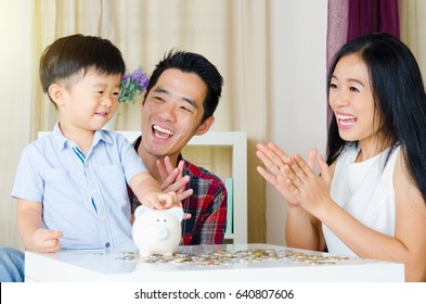 Asian Boy Putting Coins Into Piggy Bank, Junior Saving Account Conceot