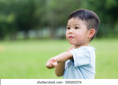 Asian Boy Scratching His Arm