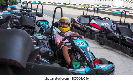 Asian Boy Sitting On Go Kart Ready For A Race.