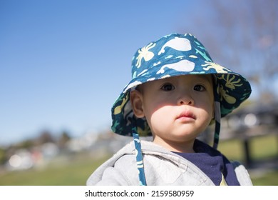 Asian Boy Toddler Wearing A Sun Hat Under The Sun In A Sunny Day 