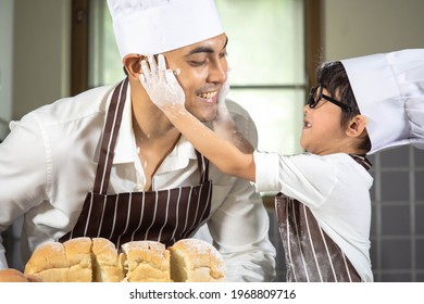 Asian Boy Wear Glasses Tease Dad Cooking With White Flour Kneading Bread Dough Teaches Children Practice Baking Ingredients Bread, Egg On Tableware In Kitchen Lifestyle Happy Learning Life With Family