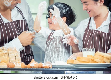 Asian Boy Wear Glasses Tease Dad Cooking With White Flour Kneading Bread Dough Teaches Children Practice Baking Ingredients Bread, Egg On Tableware In Kitchen Lifestyle Happy Learning Life With Family