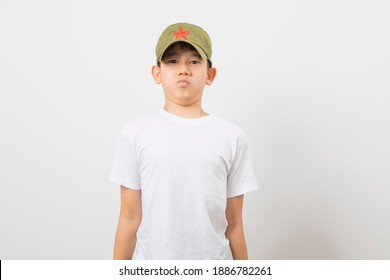 Asian Boy Wearing A Chinese Chairman Mao Zedong Communist Red Army Hat On White Background.