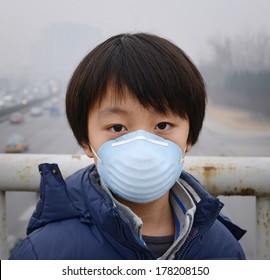 Asian Boy Wearing Mouth Mask Against Air Pollution (Beijing)