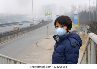 Asian boy wearing mouth mask against air pollution (Beijing)