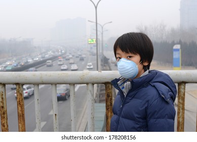 Asian boy wearing mouth mask against air pollution (Beijing)