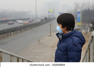 Asian Boy Wearing Mouth Mask Against Air Pollution (Beijing)