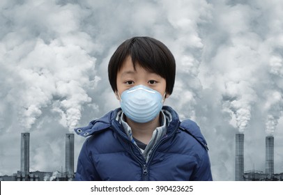 Asian boy wearing mouth mask against air pollution - Shutterstock ID 390423625