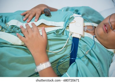 Asian Boy Wearing Sleep Apnea Diagnostic Medical Device Kit. Sleep Test Concept.