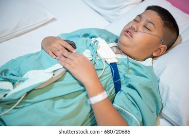 Asian Boy Wearing Sleep Apnea Diagnostic Medical Device Kit. Sleep Test Concept.