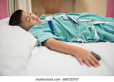 Asian Boy Wearing Sleep Apnea Diagnostic Medical Device Kit. Sleep Test Concept.