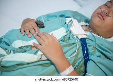 Asian Boy Wearing Sleep Apnea Diagnostic Medical Device Kit. Sleep Test Concept.