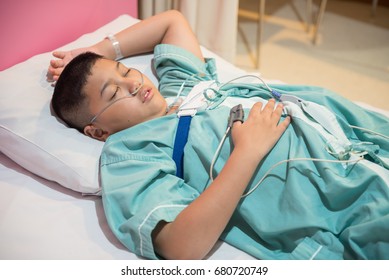 Asian Boy Wearing Sleep Apnea Diagnostic Medical Device Kit. Sleep Test Concept.