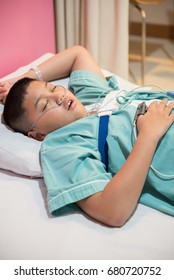 Asian Boy Wearing Sleep Apnea Diagnostic Medical Device Kit. Sleep Test Concept.