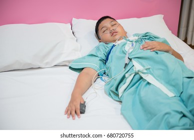 Asian Boy Wearing Sleep Apnea Diagnostic Medical Device Kit. Sleep Test Concept.