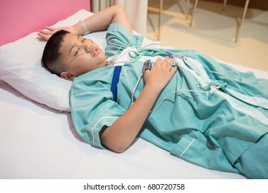 Asian Boy Wearing Sleep Apnea Diagnostic Medical Device Kit. Sleep Test Concept.