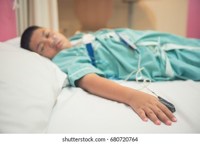 Asian Boy Wearing Sleep Apnea Diagnostic Medical Device Kit. Sleep Test Concept.