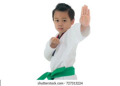 Asian boy wearing white Taekwondo suit acting ready to battle, Isolated on white background.