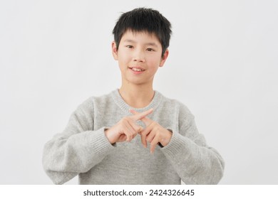 Asian boy  x sign gesture by hand in white background - Powered by Shutterstock