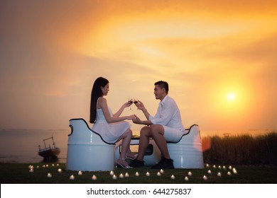 Asian boyfriend and girlfriend take diner with romantic sea, beach, candle and sunset in valentines day in tropical resort - Powered by Shutterstock