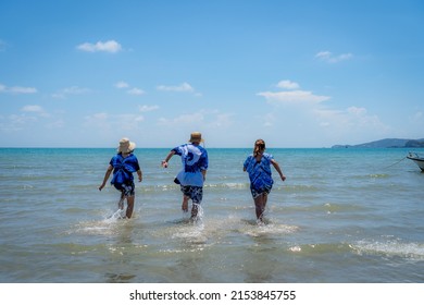 Asian Boys And Girls Run Into The Sea Excitedly Over The Summer Semester Holidays.